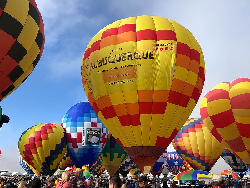 FILE - Hot air balloons are inflated during the annual Albuquerque International Balloon Fiesta in Albuquerque, N.M., on Saturday, Oct. 5, 2019. The Santa Fe Opera, Meow Wolf and the non-profit organization that puts on the Albuquerque International Balloon Fiesta are among the New Mexico businesses that received loans from the federal government as part of massive effort to support the economy amid the coronavirus outbreak. (AP Photo/Susan Montoya Bryan, file)


