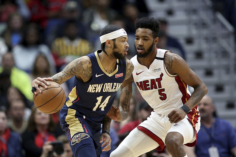 AP photo by Rusty Costanza / New Orleans Pelicans forward Brandon Ingram dribbles while guarded by Miami Heat forward Derrick Jones Jr. on March 6 in New Orleans.