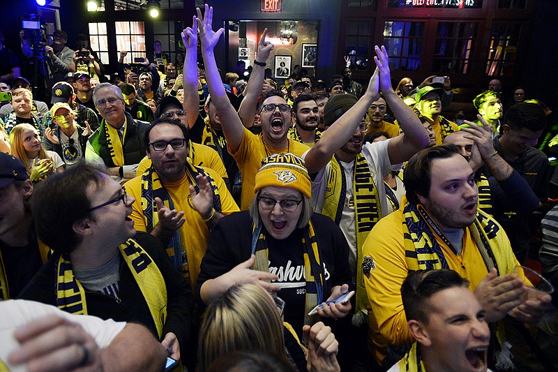 AP photo by Mark Zaleski / Nashville SC fans cheer after the team selected a player during the Major League Soccer expansion draft on Nov. 19, 2019, in Nashville.