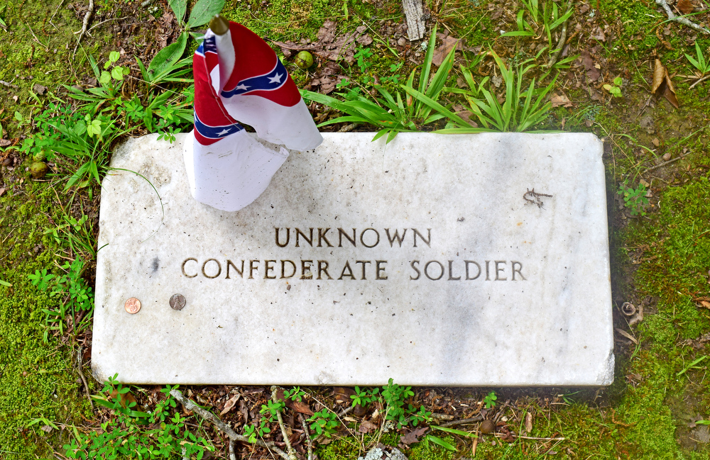 Staff Photo by Robin Rudd / The Second National Flag of the Confederacy, also known as the "Stainless Banner," decorates the grave of a unknown Confederate solider at the Resaca Confederate Cemetery. The site is the burial place of over 450 Confederate soldiers who died during the Battle of Resaca which took place May 14 and 15, 1864. Some of the soldiers were identified but 424 graves are marked "unknown".