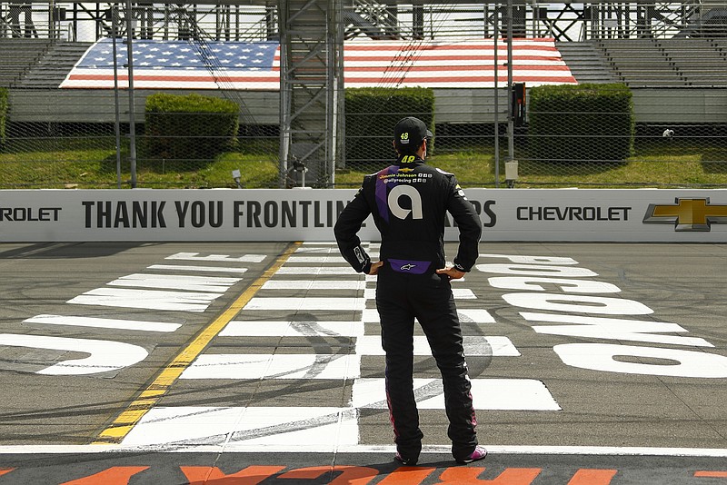 AP photo by Matt Slocum / NASCAR driver Jimmie Johnson stands near the start-finish line before the start of the Cup Series race on June 28 at Pocono Raceway in Long Pond, Pa.