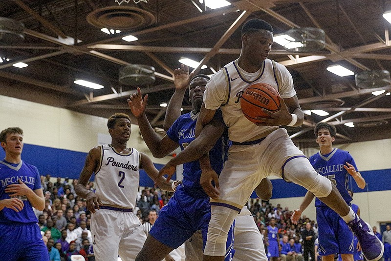 Staff photo / Central's Ryan Montgomery, right, and McCallie's Giovanni Hightower get tangled up after competing for a rebound during the Times Free Press Best of Preps boys' basketball tournament title game on Dec. 29, 2015, at Chattanooga State.