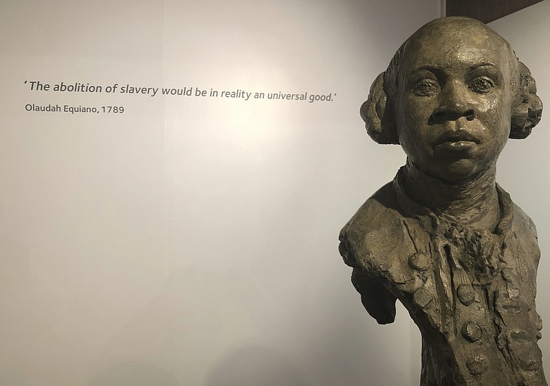 In this Nov. 24, 2019 photo, a sculpture of former slave and later abolitionist, writer Olaudah Equiano by London based artist Christy Symington, sits on display at the International Slavery Museum in Liverpool, England, Britain. Activists and towns in the U.S. are left wondering what to do with empty spaces that once honored historic figures tied to racism as statues and monuments fell in June 2020. The Equiano image has been suggested as a replacement. (AP Photo/Russell Contreras)