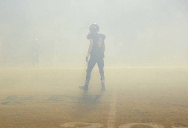 Staff Photo by Robin Rudd/ South Pittsburg's Hunter Frame (4) awaits the kickoff surrounded by the smoke of the Pirate ship. The South Pittsburg Pirates hosted the Gordonsville Tigers in the quarter finials of the TSSAA Class A football championships on November 22, 2019.