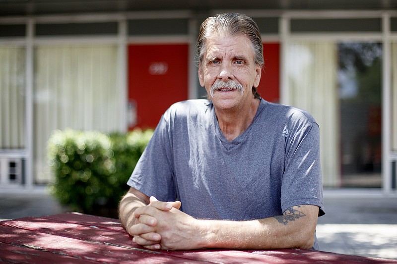 Staff photo by C.B. Schmelter / Mike "Boogie" Gilbert poses in a common area outside of his motel room on Wednesday, July 8, 2020 in Dalton, Ga. Gilbert was displaced after an EF3 tornado tore through Murray County on Easter.