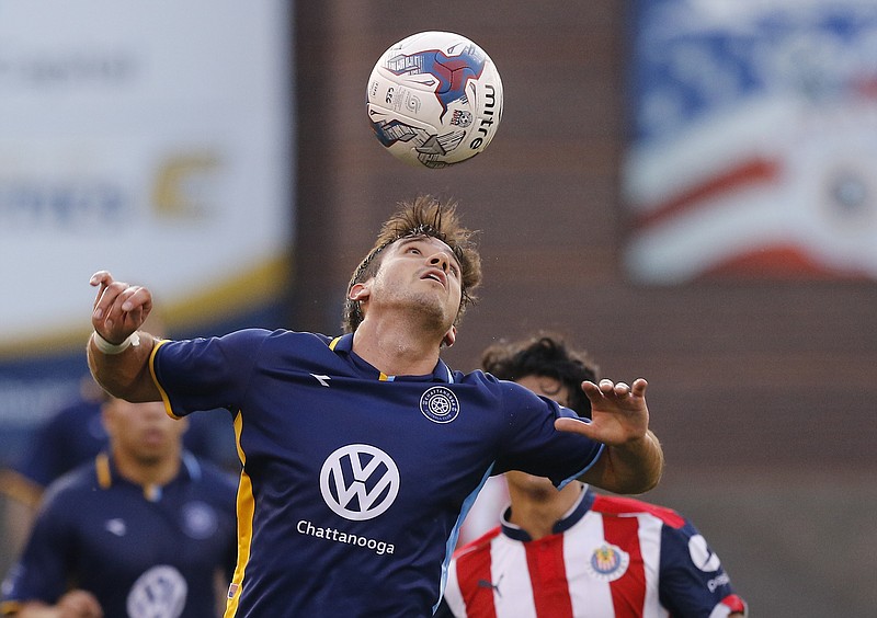 Staff file photo / Chattanooga Football Club's Jose "Zeca" Ferraz heads the ball during an exhibition match against Mexican soccer club Chivas U23 on May 27, 2017, at Finley Stadium.