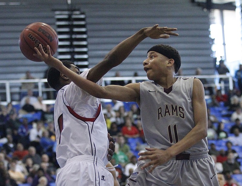 Staff photo / Tyner's Devante Jones drives to the basket around East Nashville's Patrick Smith during a TSSAA Class AA state tournament game on March 13, 2014, at Middle Tennessee State. Tyner lost 81-62.