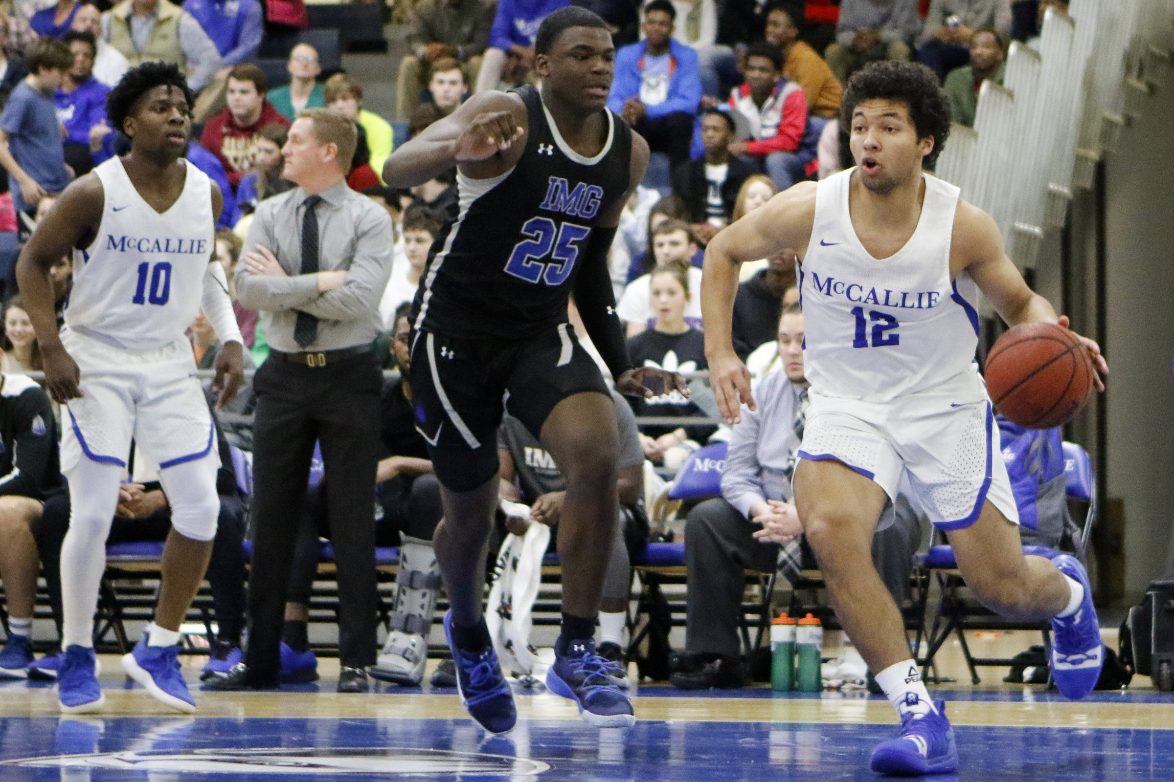 Staff file photo by C.B. Schmelter / McCallie's Anthony Watkins (12) drives against Jarace Walker (25) and IMG Academy during The McCallie Dr Pepper TEN Classic at the Walker Forum on the campus of the McCallie School on Friday, Feb. 1, 2019 in Chattanooga, Tenn.