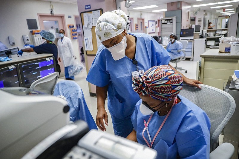  FILE - In this May 27, 2020, file photo, medical personnel work in the emergency department at NYC Health + Hospitals Metropolitan in New York. As coronavirus rages out of control in other parts of the U.S., New York is offering an example after taming the nation's deadliest outbreak this spring — but also trying to prepare in case another surge comes. (AP Photo/John Minchillo, File)