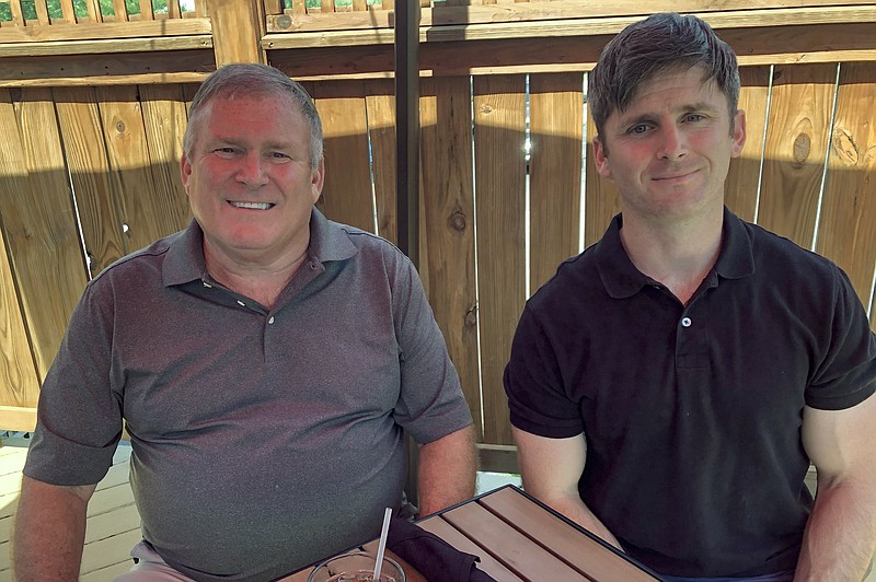 This photo from June 26, 2020 shows Buck Newsome, left, a Baby Boomer, and his son, Chris Newsome, of the Millennial generation, as they pose for a photo while having lunch together in Newtown, Ohio. American's two largest generations can agree on something: the coronavirus pandemic has hit them both hard. For Baby Boomers, named for the post-World War II surge of births, that means those who retired or are nearing retirement age are seeing their retirement accounts in a free fall. Millennials, usually defined as those born between 1981 and 1996, who became adults in this century, are getting socked as they were trying to begin careers or moving into peak earning years after many walked off college campuses into the Great Recession. (AP Photo/Dan Sewell)


