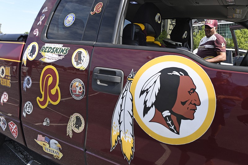 AP photo by Susan Walsh / Rodney Johnson of Chesapeake, Va., stands with his truck outside FedEx Field in Landover, Md., on Monday, the same day the NFL franchise based in the Washington, D.C., announced it had dropped the Redskins name and Indian head logo immediately, bowing to decades of criticism that both are offensive to Native Americans.


