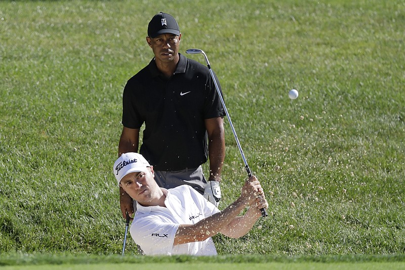AP photo by Darron Cummings / Tiger Woods watches as Justin Thomas hits out of a bunker on the 15th hole at Muirfield Village Golf Club during Tuesday's practice round for the Memorial Tournament, which starts Thursday in Dublin, Ohio.