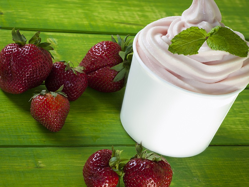 Cup of strawberry frozen yogurt or soft serve ice cream with fresh fruit. soft serve ice cream fruit tile / Getty Images
