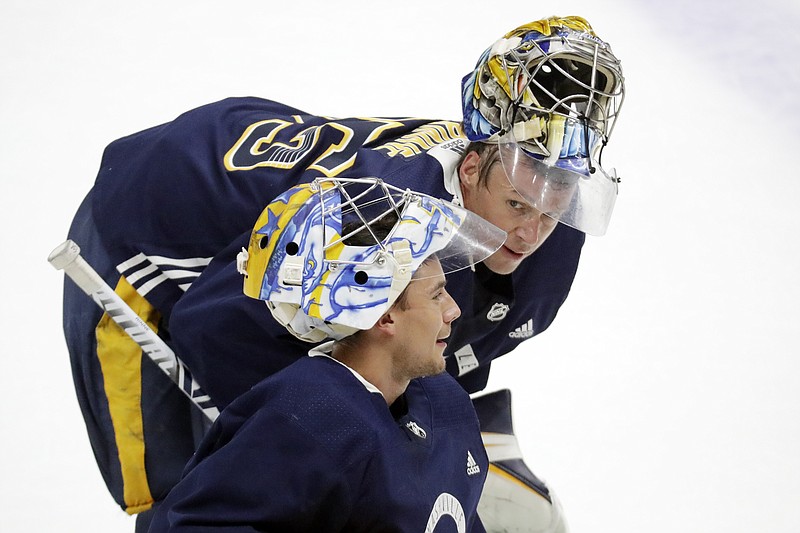 AP photo by Mark Humphrey / Nashville Predators goaltenders Juuse Saros, bottom, and Pekka Rinne are both from Finland, and they have a rare relationship in helpfully pushing each other despite competing for the same starting spot for their NHL team.