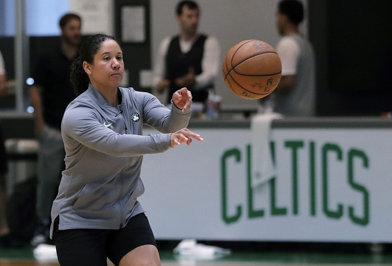 AP photo by Charles Krupa / Assistant coach Kara Lawson passes the ball as the Boston Celtics practice at the NBA team's training facility on July 1, 2019.