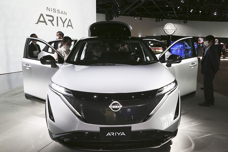 Nissan Motor Co.'s new electric crossover Ariya is displayed at Nissan Pavilion in Yokohama near Tokyo Tuesday, July 14, 2020. The Ariya is the Japanese automaker's first major all-new model since getting embroiled in the scandal surrounding former Chairman Carlos Ghosn. The vehicle, set to go on sale in Japan by the middle of next year, and in Europe, North America and China by the end of 2021, costs about 5 million yen ($46,000).(AP Photo/Koji Sasahara)