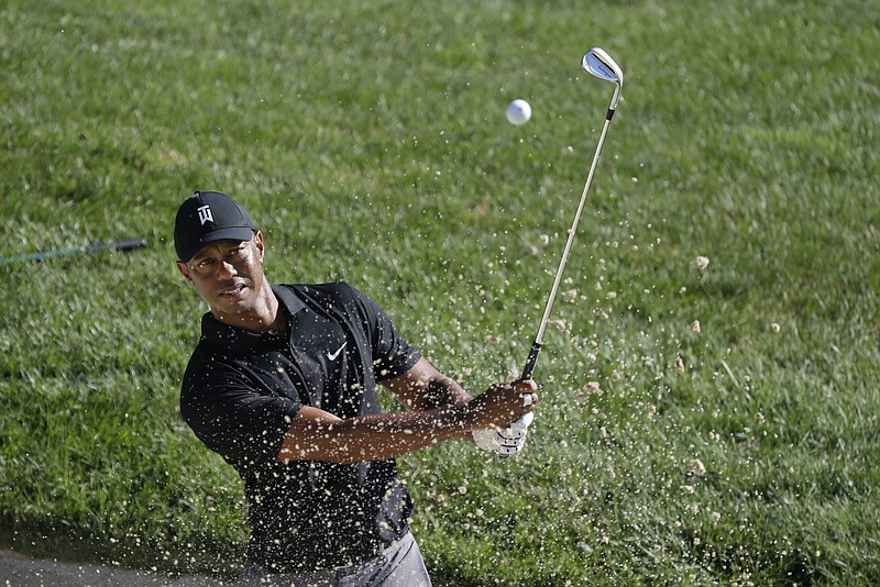 AP photo by Darron Cummings / Tiger Woods hits out of a bunker on the 15th hole at Muirfield Village Golf Club during a practice round Wednesday for the Memorial Tournament, which starts Thursday in Dublin, Ohio.