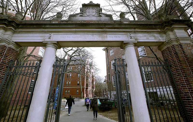 Photo by Charles Krupa of The Associated Press / In this Dec. 13, 2018, file photo, a gate opens to the Harvard University campus in Cambridge, Massachusetts.