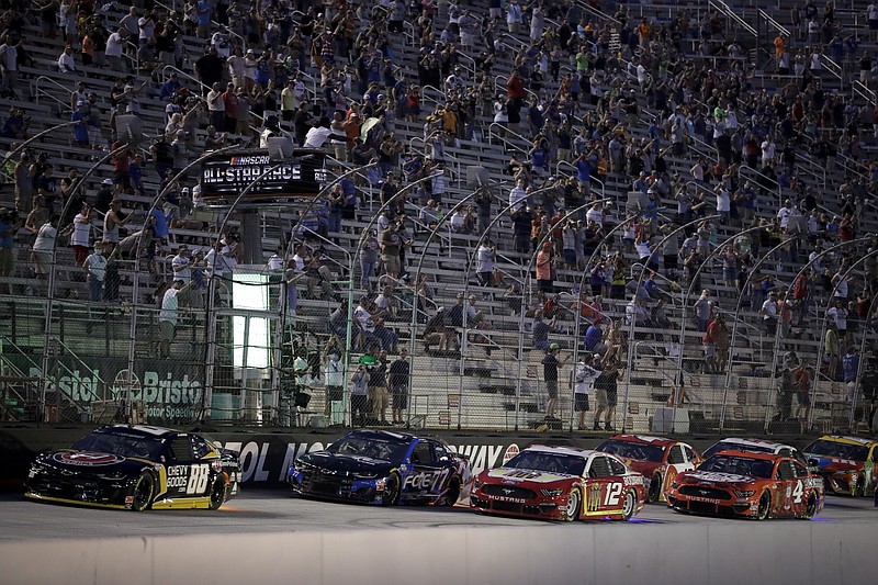 AP photo by Mark Humphrey / Fans watch as Alex Bowman (88) and other drivers compete during the NASCAR All-Star Race on Wednesday night at Tennessee's Bristol Motor Speedway.