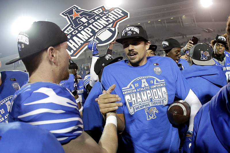 AP photo by Mark Humphrey / Memphis quarterback Brady White, center, celebrates after the Tigers defeated visiting Cincinnati to win the American Athletic Conference championship on Dec. 7, 2019, in Memphis.