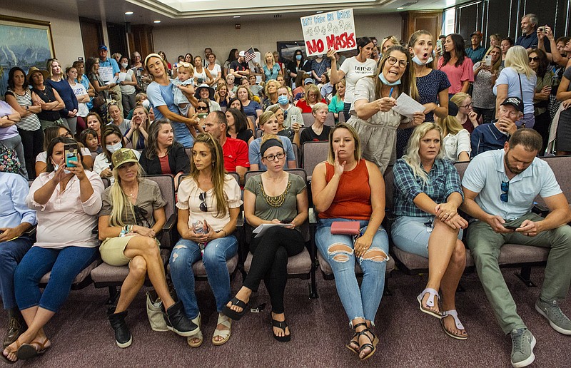 Angry residents react when the Utah County Commission meeting was adjourned before it even started, Wednesday, July 15, 2020, in Provo, Utah. The group protesting against face masks being required in schools removed the social distancing tape on the chairs and filled the Utah County Commission room to over flowing, prompting Commissioner Tanner Ainge to call for a vote to adjourn the meeting. (Rick Egan/The Salt Lake Tribune via AP)


