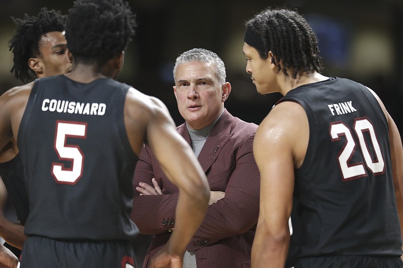 AP photo by Mark Humphrey / South Carolina men's basketball coach Frank Martin talks to Jermaine Couisnard and Alanzo Frink during a game against Vanderbilt on March 7 in Nashville.