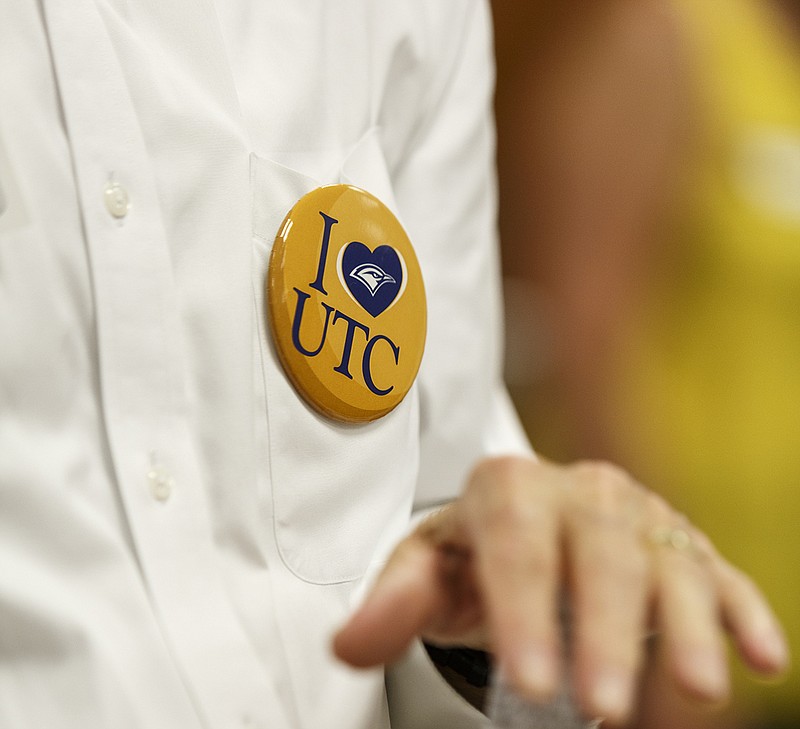 Staff photo / Fred Obear wears a button supporting UTC during a news conference introducing Mark Wharton as the school's new athletic director on Aug. 23, 2017.