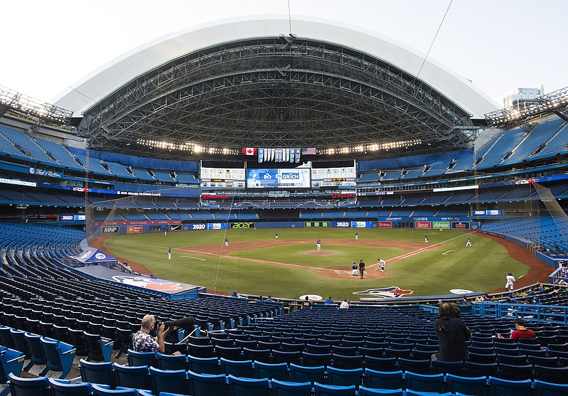 AP photo by Nathan Denette / Photographers take pictures at Rogers Centre as the Toroto Blue Jays play an intrasquad game on Friday.