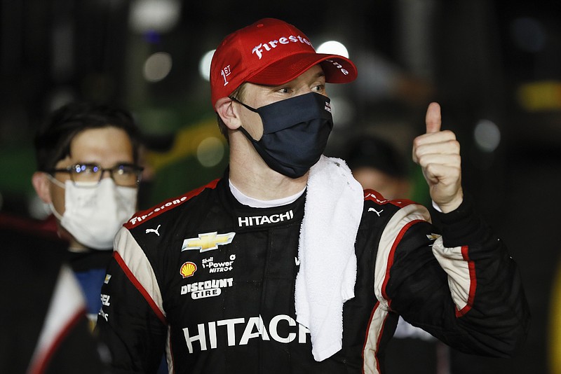 AP photo by Charlie Neibergall / Josef Newgarden celebrates in victory lane at Iowa Speedway after winning Saturday night's IndyCar race in Newton.