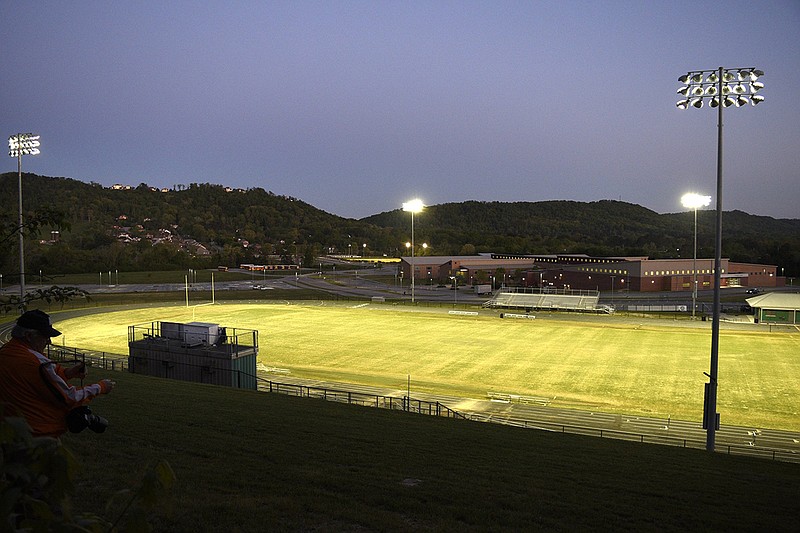 Staff photo by Robin Rudd / East Hamilton's Larry Henry Field glows under the lights with the soccer field illuminated in the distance on April 10 to honor athletes who had their spring sports seasons canceled because of the coronavirus pandemic.