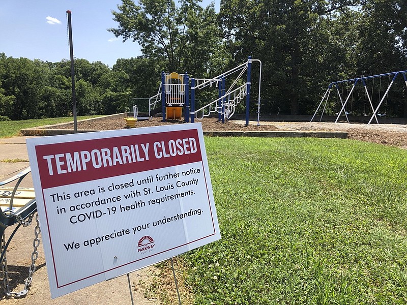 A sign alongside a playground at Hanna Woods Elementary School in the Parkway School District in suburban St. Louis indicates that the playground is closed due to the coronavirus pandemic, Saturday, July 18, 2020. Parkway has formulated a flexible plan to reopen schools when the fall semester begins Aug. 24. Just how bad the virus is at the time will determine if schools open completely, if they mix online and in-person classes, or if they are forced to go strictly virtual. (AP Photo/Jim Salter)