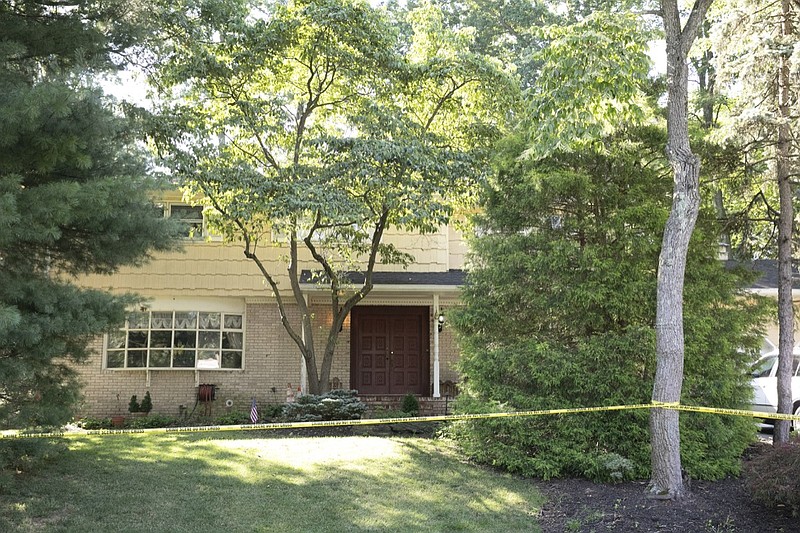 Crime scene tape surrounds the home of U.S. District Judge Esther Salas, Monday, July 20, 2020, in North Brunswick, N.J. A gunman posing as a delivery person shot and killed Salas' 20-year-old son and wounded her husband Sunday evening at their New Jersey home before fleeing, according to judiciary officials. (AP Photo/Mark Lennihan)