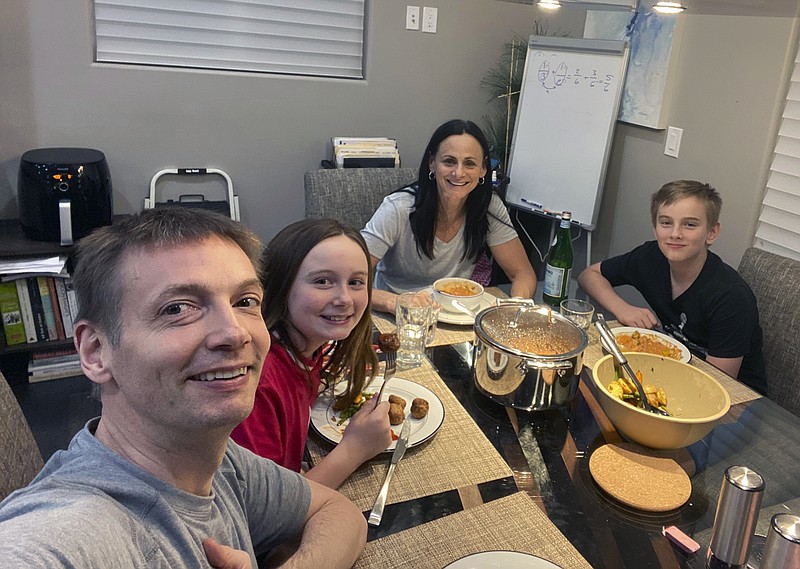 Chicago Sky photo by Olaf Lange via AP / Phoenix Mercury coach Sandy Brondello, rear, her husband Olaf Lange, left, an assistant coach for the Chicago Sky, and their children Brody, right, and Jayda eat on May 20 in Phoenix while quarantining at home.