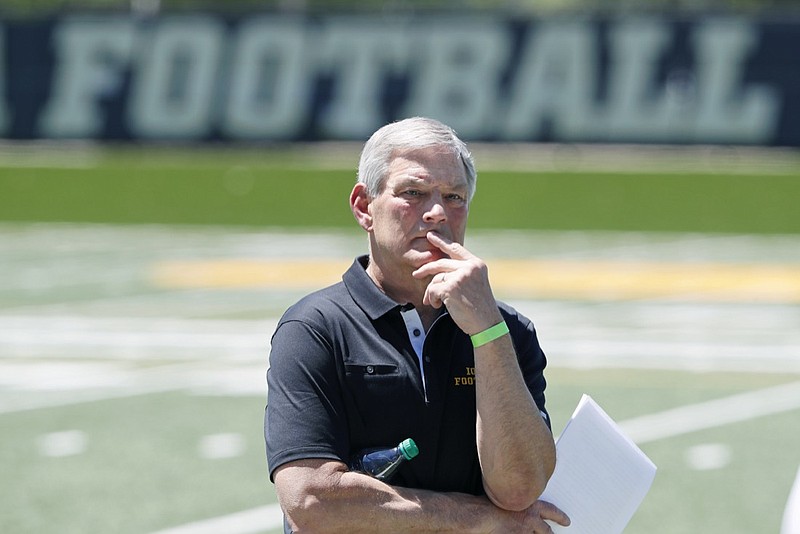 AP photo by Charlie Neibergall / Iowa football coach Kirk Ferentz listens to one of his players speak during a news conference on June 12 in Iowa City.