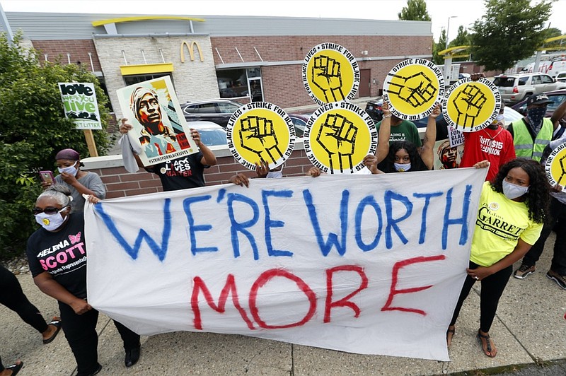 Protesters rally outside a McDonald's in Detroit, Monday, July 20, 2020. The national workers strike saw people walk off the job Monday in U.S. cities to protest systemic racism and economic inequality. (AP Photo/Paul Sancya)

