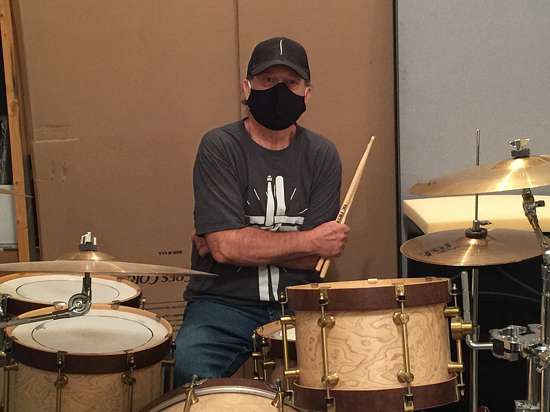 Bill Brewer, 70, teaches drum lessons from a storage unit converted into a music studio in Rossville, Georgia. Brewer has managed to keep his business afloat by using Zoom for remote teaching. Staff photo by Mark Kennedy.