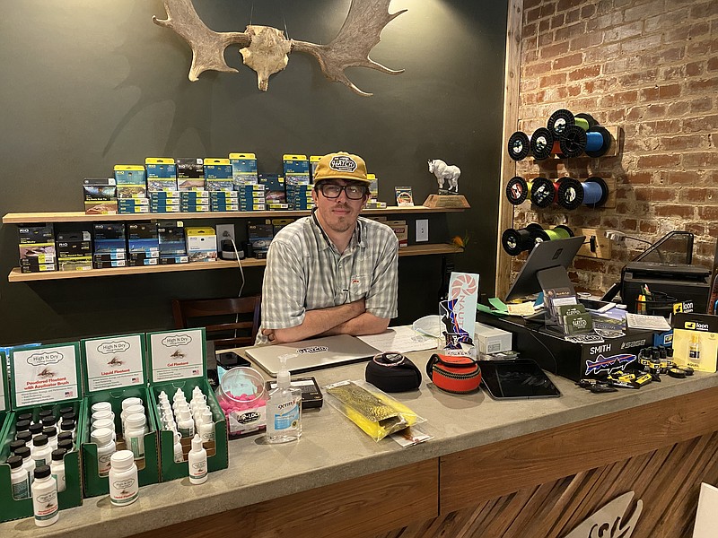 Photo by Barry Courter / Seth Fields is the new owner of Hatch Outfitters on Brainerd Road. The full service shop offers rods, reels, classes, clothing and now a beer bar.