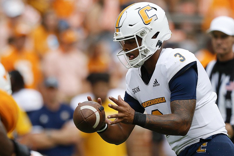 Staff photo by C.B. Schmelter / UTC quarterback Drayton Arnold takes a snap during the Mocs' game at Tennessee last Sept. 14. Arnold completed five of 10 passes against the Vols.
