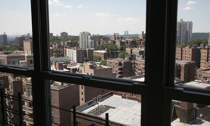 Joyce and Anil Lilly's 14th floor apartment overlooks other apartment buildings, Tuesday, July 21, 2020, in The Bronx borough of New York. They have bought a house an hour's drive north of the city, amid the coronavirus pandemic. "Because we were locked into the apartment for three months, a solid three months, I feel like I'm getting out of prison and I want to run as far away as possible," said Joyce. (AP Photo/Mark Lennihan)


