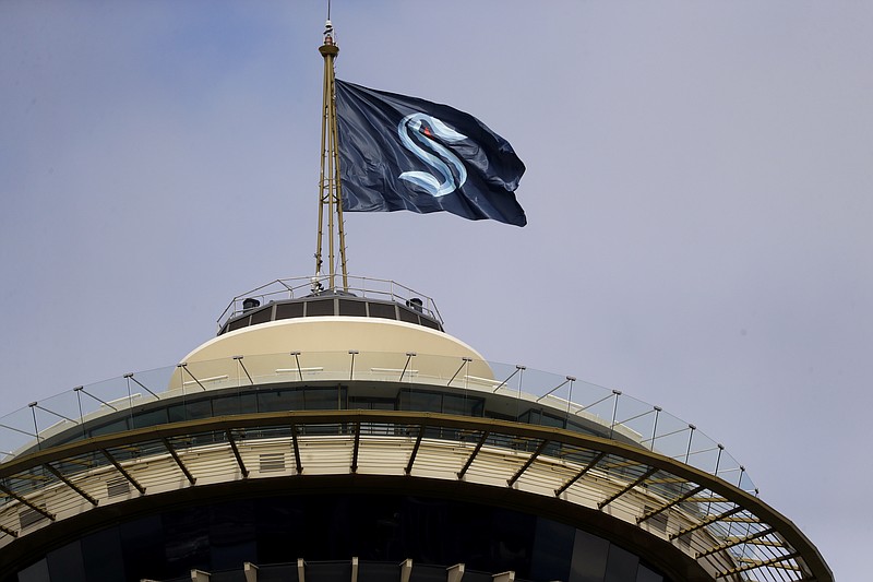 AP photo by Elaine Thompson / A flag with the logo for the newly named NHL expansion franchise, the Seattle Kraken, flies atop the iconic Space Needle on Thursday. The team is set to make its debut on the ice in the 2021-22 season.