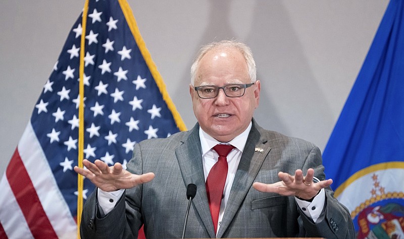 FILE - In this Tuesday, July 21, 2020 file photo, Minnesota Gov. Tim Walz provides an update in St. Paul, Minn., on the state's plan to mitigate the impact of COVID-19 in long-term care facilities. Walz is expected to sign a police accountability bill into law Thursday, July 23 that includes a ban on neck restraints like the one that was used on George Floyd before his death in Minneapolis. (Glen Stubbe/Star Tribune via AP, File)