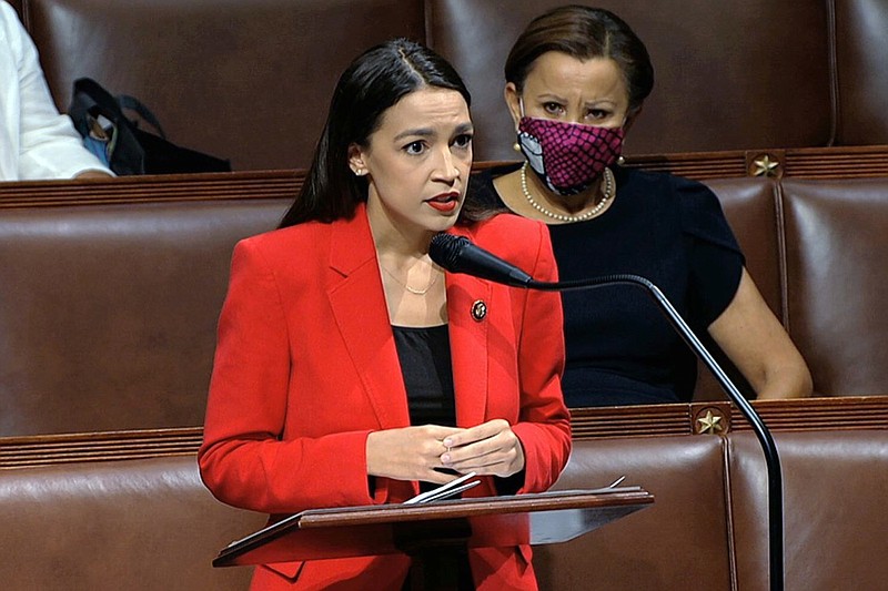 In this image from video, Rep. Alexandria Ocasio-Cortez, D-N.Y., speaks on the House floor, Thursday, July 23, 2020 on Capitol Hill in Washington. Ocasio-Cortez's objections to a Republican lawmaker's verbal assault on her expanded Thursday as she and other Democrats took to the House floor to demand an end to a sexist culture of "accepting violence and violent language against women." Rep. Nydia Velázquez, D-N.Y., is seated right. (House Television via AP)