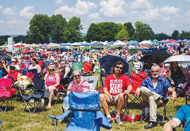Fans listen as The Young Escape performs during the JFest Christian music festival in its new location at the Tennessee Riverpark on Saturday, May 18, 2019, in Chattanooga, Tenn. After outgrowing its Camp Jordan venue, the annual festival moved to the larger area along the Tennessee River.