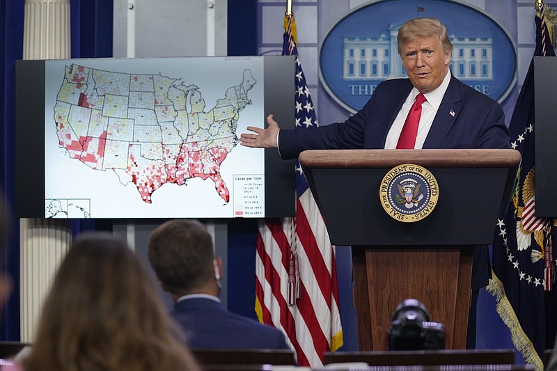 Photo by Evan Vucci of The Associated Press / President Donald Trump gestures towards a screen displaying a graphic on the coronavirus outbreak as he speaks during a news conference at the White House on July 23, 2020, in Washington.