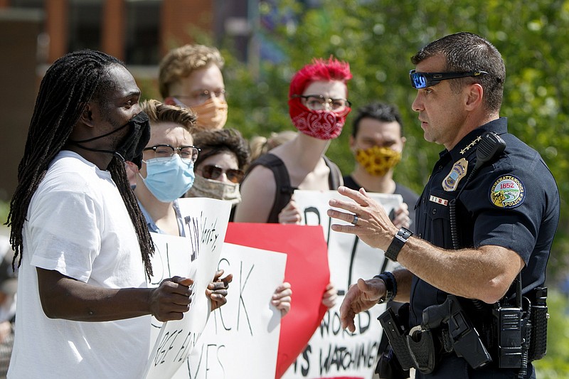 Staff photo by C.B. Schmelter / Chattanooga Police Department Chief David Roddy, right, talks to a protestor at Miller Park on Saturday, May 30, 2020 in Chattanooga, Tenn. People gathered to protest the killing of George Floyd. Floyd, 46, died after being handcuffed and pinned for several minutes beneath Minneapolis police Officer Derek Chauvin's knee.