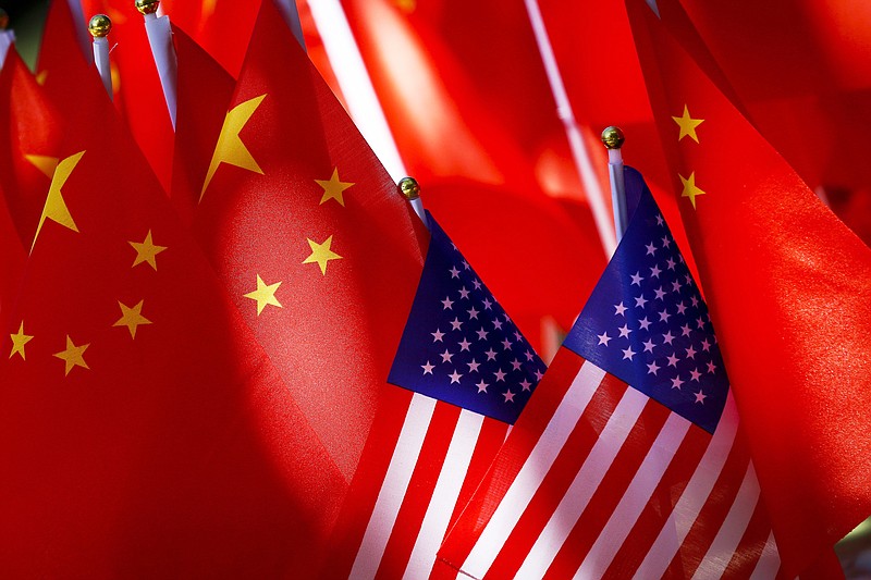  In this Sept. 16, 2018, file photo, American flags are displayed together with Chinese flags on top of a trishaw in Beijing. On Friday, July 24, 2020, China has ordered the United States to close its consulate in the western city of Chengdu in an increasingly rancorous diplomatic conflict. The order followed the U.S. closure of the Chinese consulate in Houston. (AP Photo/Andy Wong, File)