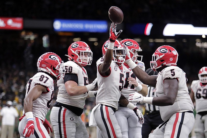 AP photo by Brett Duke / Georgia wide receiver Matt Landers, with ball, celebrates his touchdown catch against Baylor during the Sugar Bowl on Jan. 1 at the Mercedes-Benz Superdome in New Orleans. College football's 2020-21 bowl schedule of 42 games, plus the College Football Playoff final, is far from set with the COVID-19 pandemic casting doubts on even the regular season.