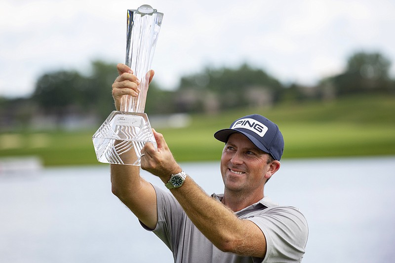 Michael Thompson holds the trophy after winning the 3M Open golf tournament in Blaine, Minn., Sunday, July 26, 2020. (AP Photo/Andy Clayton- King)