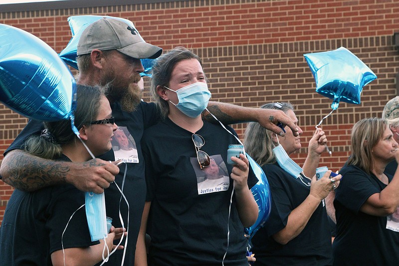 Staff photo by Wyatt Massey / Mike Dewhurst, center, consoles family during the July 26 vigil for his brother Joseph Dewhurst, who died while in custody at the Bradley County Jail.