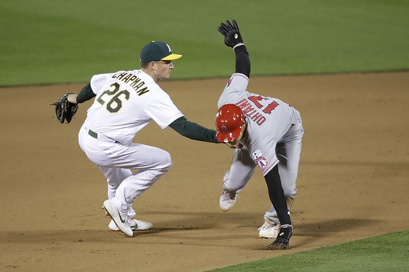Oakland Athletics third baseman Matt Chapman (26) tags out Los Angeles Angels' Shohei Ohtani during the tenth inning of a baseball game in Oakland, Calif., Friday, July 24, 2020. (AP Photo/Jeff Chiu)